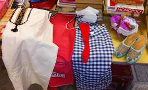 lot 822 image: Vintage Lot socks, dresses, apron, shoes, suspenders and more.