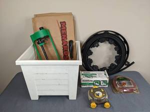lot 54 image: An Assortment of Lawn Care Items Sprinklers, Lawn Bags, Nelson Sprinkler Timer, Grass Gator Trimmer Line, Glamos, Etc.