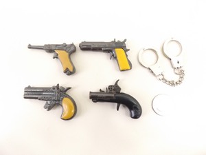 lot 36 image: 4 Miniature Cap Guns and 1 Set of Miniature Handcuffs