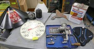lot 194 image: Misc garage lot - squirrel baffle, thermometer, sockets, grinder, waterseal, bike seat