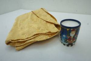 lot 47 image: Gold tablecloth and candle