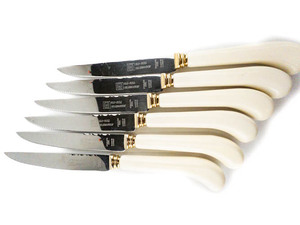 lot 43 image: Glo-Hill Co. Set of 6 Celebration Steak knifes with white handle and salad tongs  .
