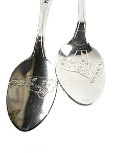 lot 115 image: Fort Inc. Pair of Miniature Souvenir Spoons (I  New York, North Carolina) Silver Plated.