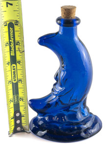 lot 125 image: Cobalt Blue Man-in-the-Moon with Cherub at base, Bottle with Cork, 6in Flashed Color Pattern Glass.