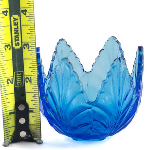 lot 168 image: Periwinkle Blue Leaf Motif Votive Holder with feet, 2 34in Pattern Glass.
