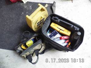 lot 38 image: Wind-up extension cord reel plus 2-Soft side tool bags with a large assortment of tape measures, wire strippers, screwdriver bits, drill bits and more