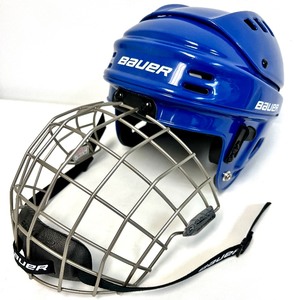 lot 46 image: 2 Hockey Sticks  3 Packs of Hockey Tape and 2 BAUER Helmets