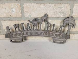 lot 373 image: Cast Aluminum License Plate Topper - Miami Florida - Top of left palm tree is broken off
