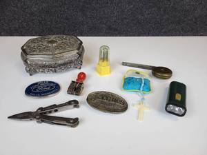 lot 486 image: Vintage Jewelry Box with Belt Buckles, Tools, Vintage Dater Stamp (Latest year is 1935), Brass Measuring Tape, and More