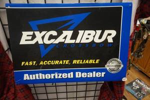 lot 7 image: Excaliber Cross Bows Promotional Sign and Sticker