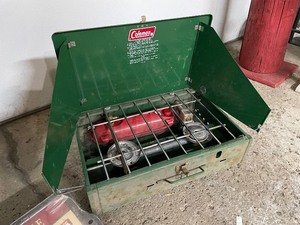 lot 198 image: Camping Gear Lot - Coleman Gas Cook Stove, Coleman Flourescent Battery Powered Lantern, Aluminum Pot and Camp Griddle