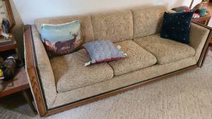 lot 56 image: Vintage Upholstered Sofa with wood trim and accents plus pillows