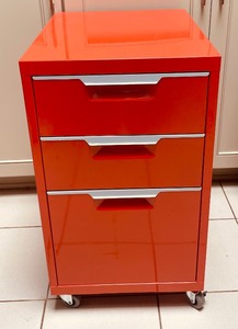 lot 64A image: Blaze Orange Three Drawer File Cabinet on Casters