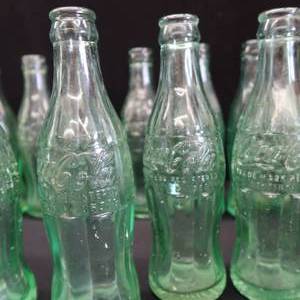 lot 25 image: 16 VINTAGE COCA COLA BOTTLES MOST MINNESOTA BOTTLED