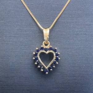 lot 41 image: Natural Blue Sapphire Open Halo Heart Cluster Pendant in Yellow Gold
