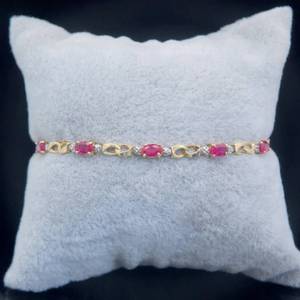 lot 32 image: 3.00 Carat Ruby & Diamond Infinity Symbol Ribbon Link Tennis Bracelet in Yellow Gold $1,660 Retail
