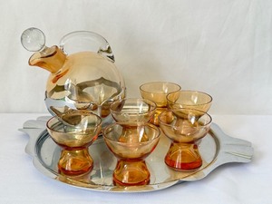 lot 150 image: Cambridge Amber Tilt Decanter wOriginal Stopper in Farberware Holder, Farberware Tray, (6) Amber Cambridge Whiskies