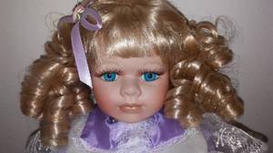 lot 723 image: Collectible Doll with stand (2). 