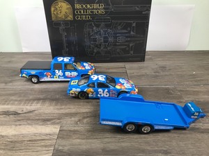 lot 70 image: 1999 Nascar Brookfield Collectors Guild 3 piece set Ernie Irvan #36 M&Ms - Pontiac Grand Prix Race Car - GMC Crew Cab - Open Trailer 124 scale die cast