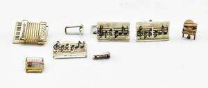 lot 101 image: Music-Themed Assortment of Pins and Trinkets