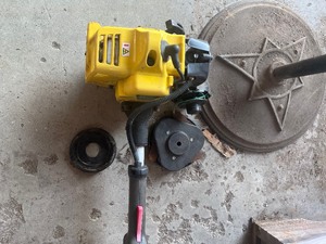 lot 55 image: Weed eater for parts or repair  runs but needs the head put back on