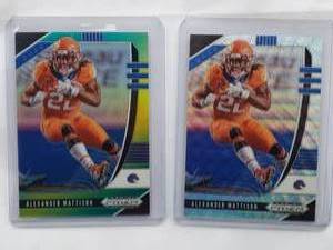 lot 252 image: Lot of 2 Alexander Mattison Rookie Prizm Refractors.  One is Numbered 124299, the other 213249