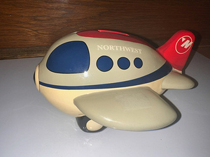 lot 104 image: Northwestern Airlines Play Set Northwest ceramic piggy bank