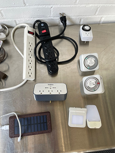 lot 166 image: Lot of power strips, extension chords, night lights, timers, and power storage