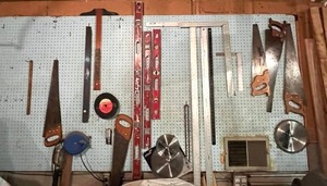 lot 13 image: Garage Wall Contents (Levels, Saws, Saw Blades, and More)