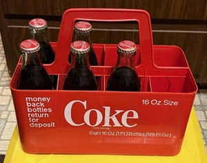 lot 59 image: Vintage Coca Cola Classic Full Glass Soda Bottles with Carrier