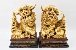 lot 35 image: Pair of Gilt Wooden Foo Dogs