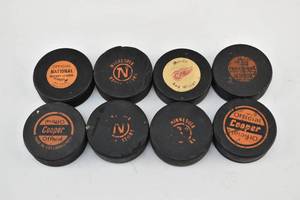 lot 69 image: 8 Used Hockey Pucks