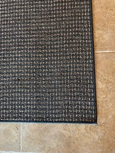 lot 33 image: Black and Tan Jute Backed 5 ft x 7 ft Area Rug
