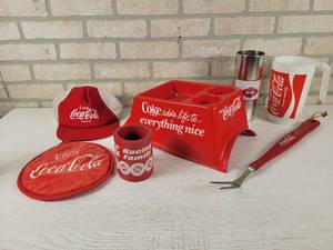 lot 182 image: Large Lot of Assorted Coca-Cola Collectables - Center Console Cup Holder, Hot Pad, Can Koozie and More