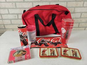 lot 184 image: Large Lot of Assorted Coca-Cola Collectables - (3) Sets of Playing Cards, Paper Ads, Cups and Red Duffel Bag