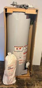 lot 216 image: US Craftmasters Water Heater Self Cleaning NIB (Has Dent) Still Good, With Water Heater Blanket (BRING YOUR OWN HELP TO LOAD) IN BASEMENT