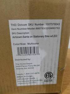 lot 104 image: 5.5 ft. LED Inflatable Santa on Stationary Bike White Fiber