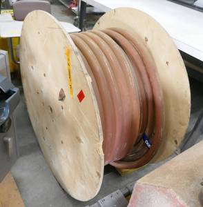 lot 44 image: Large reel of what looks like gas pump hose