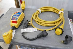 lot 122 image: Power Grip Power Defender 50A power monitor surge protector and cables for RV