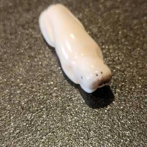 lot 33 image: Alaskan Carved Bone Walrus Button Figurine