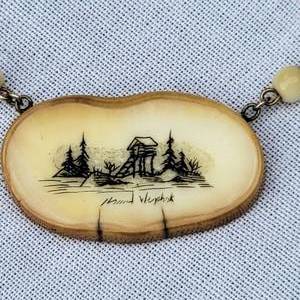 lot 70 image: Inuit Carved and Engraved Bone Necklace and Brooch, signed