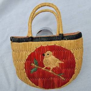 lot 98 image: Old Childs Woven Straw Purse with Bird on a Branch