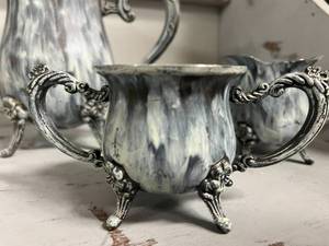 Painted Silver Teapot with matching cream and sugar.