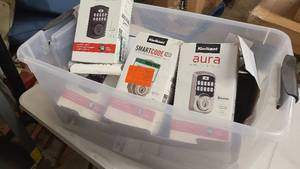 Small clear bin of door handle and lock equipment