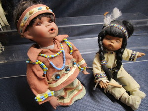 lot 130 image: Indigenous dolls 10, seated 7 gi...