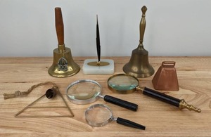 lot 99 image: Assortment of Magnifiers, Single Bell Triangle Wind Chime, Desk Pen Holder, School Bell, Dinner Bell and Cow Bell D
