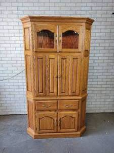 lot 651 image: Solid Wood Corner Cabinet with Cathedral Glass Doors in an Autumn Oak Finish - NO SHIPPING