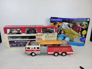 lot 697 image: Discovery Channel Construction Fort, Lemax Village Express Holiday Train Set, and Fire Engine