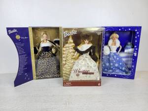 lot 733 image: Set of (3) Barbie Dolls - 2001 Ring in the New Year Barbie, 2001 Winter Classic Barbie, and 1999 Snow Sensation Barbie