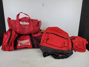 lot 905 image: Lot of (4) Bags - (3) Marlboro Duffel Bags and (1) Red PolyesterBlack Vinyl Backpack